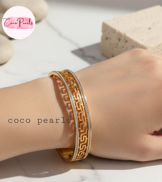 Coco Pearls Stainless Steel Anti Tarnish Gold greco glam handcuff bracelet on a wrist