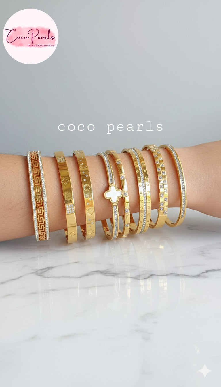 Coco Pearls Stainless Steel Anti tarnish gold stack of handcuffs displayed on hand