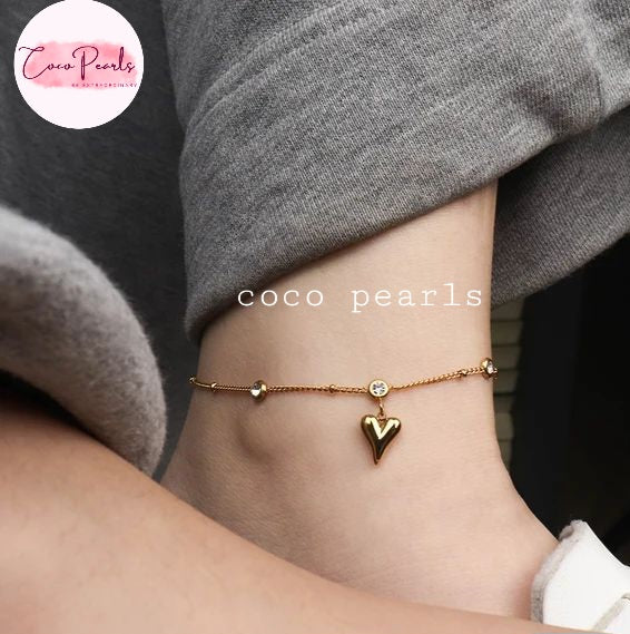 Coco Pearls Stainless Steel Anti Tarnish Gold heartbeat anklet with hanging heart charm and stones worn on an ankle