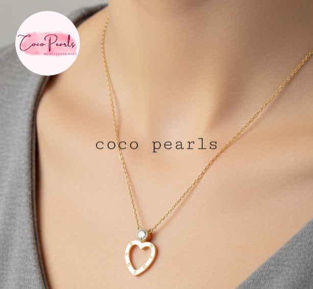 Coco Pearls Stainless Steel Anti Tarnish Gold necklace with a heart-shaped pendant and a diamond on a model