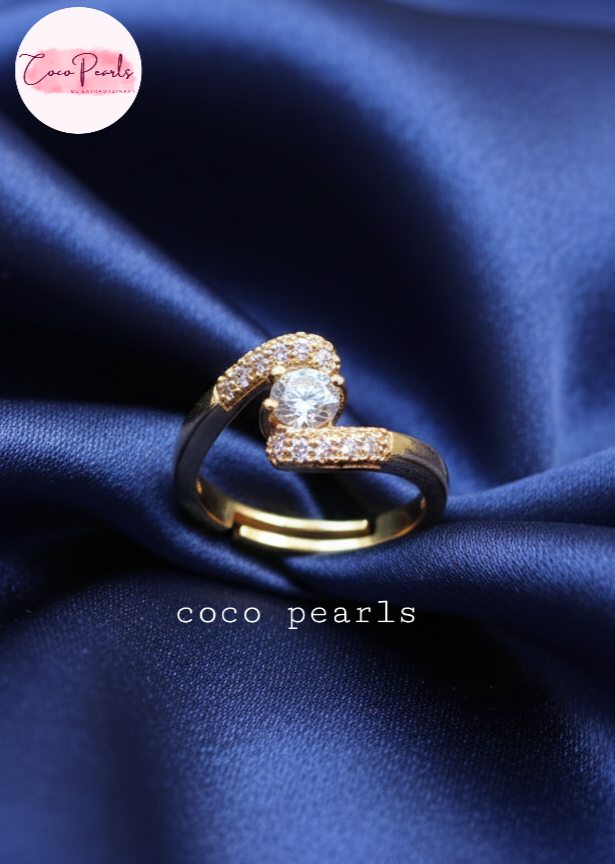 coco pearls stainless steel anti tarnish gold heart spark ring diamond studded with a big diamond in center displayed on blue satin