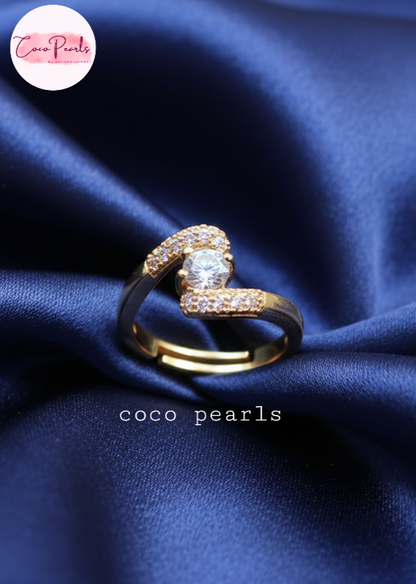 coco pearls stainless steel anti tarnish gold heart spark ring diamond studded with a big diamond in center displayed on blue satin
