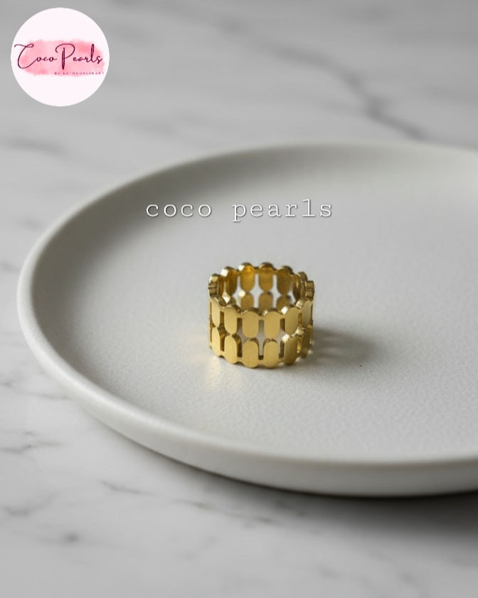 Coco Pearls Stainless Steel Anti Tarnish Gold honeycomb glam ring on a simple background