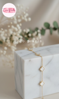 Coco Peals Stainless Steel anti  tarnish Gold little clover bracelet with clover-shaped charms on a white surface