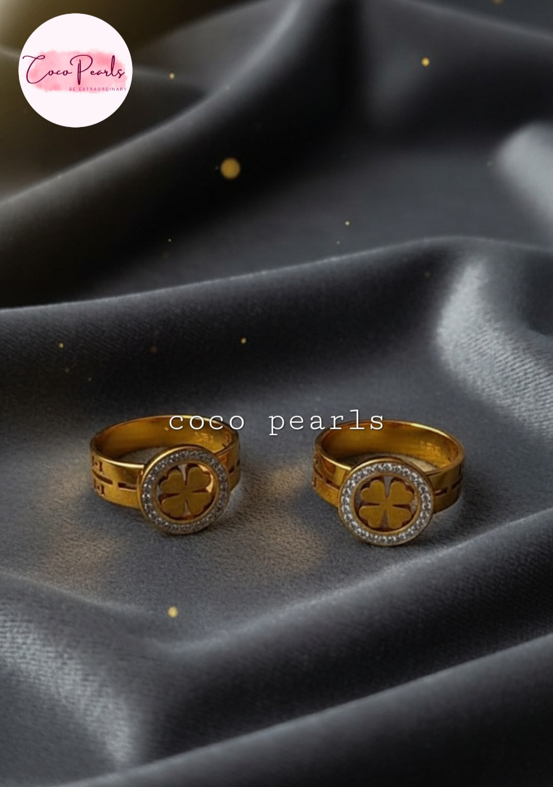 Coco Pearls Stainless Steel Anti Tarnish Gold luck charm ring with gemstones studded clover charm on a gold band on a black background 