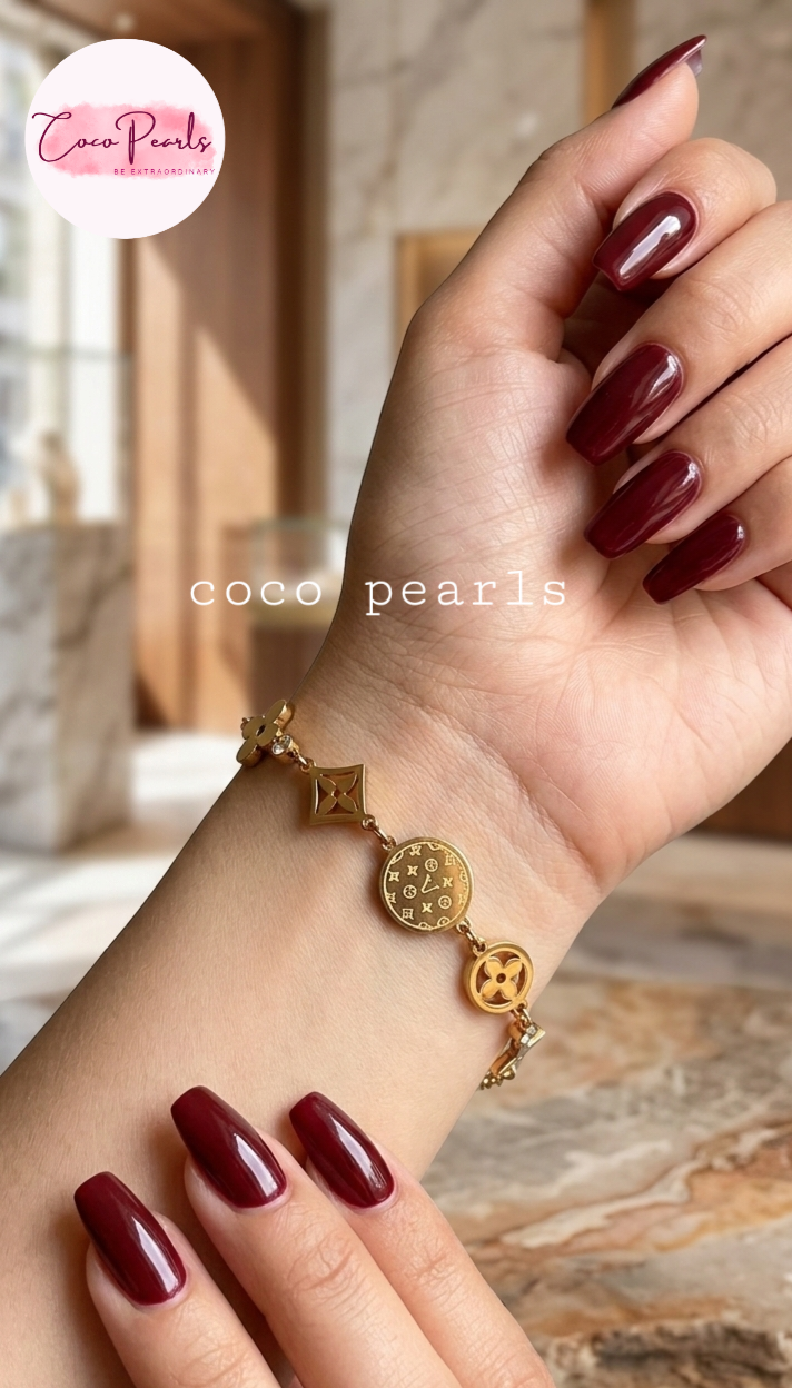 coco pearls stainless steel anti tarnish Gold lucky charm bracelet with intricate designs on hand