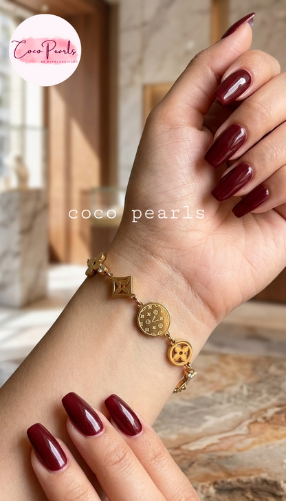 coco pearls stainless steel anti tarnish Gold lucky charm bracelet with intricate designs on hand