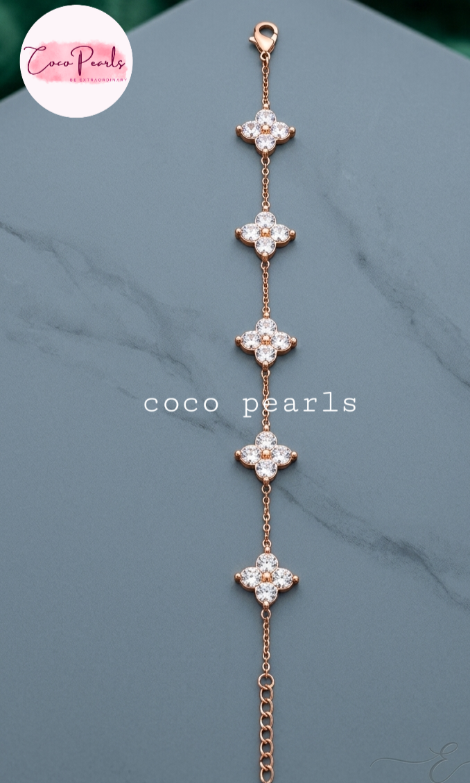 coco pearls stainless steel jewelry pakistan anti tarnish waterproof gold lucky four clover shaped bracelet displayed on alight background