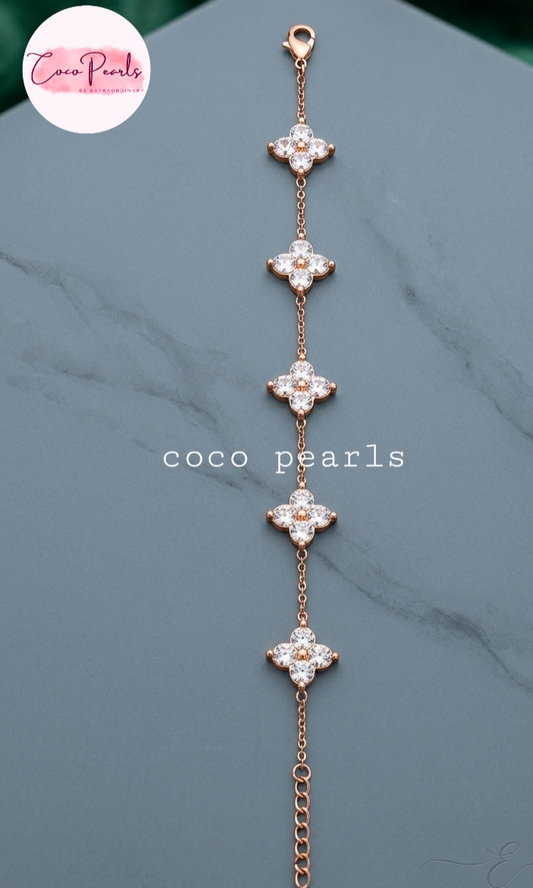 coco pearls stainless steel jewelry pakistan anti tarnish waterproof gold lucky four clover shaped bracelet displayed on alight background