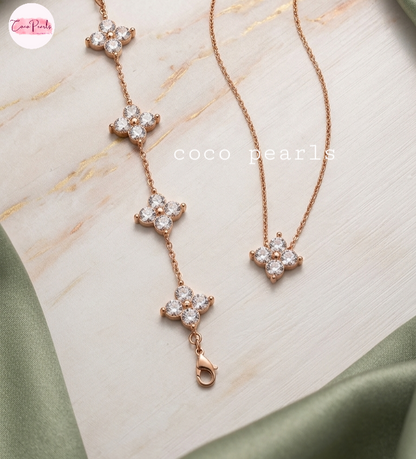 coco pearls stainless steel jewelry pakistan anti tarnish waterproof gold lucky four clover shaped diamond studded necklace and bracelet displayed on alight background