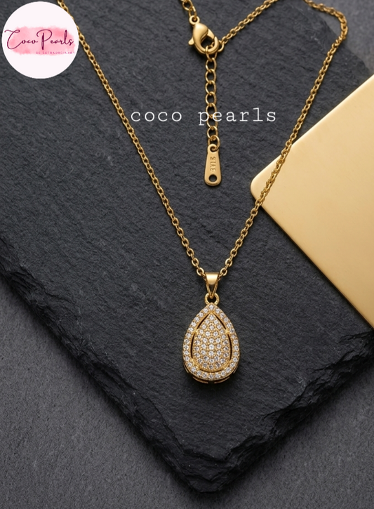 coco pearls stainless steel pakistan anti tarnish waterproof Gold luxe drop necklace with diamond studded drop pendant on a dark background