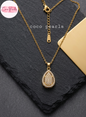 coco pearls stainless steel pakistan anti tarnish waterproof Gold luxe drop necklace with diamond studded drop pendant on a dark background