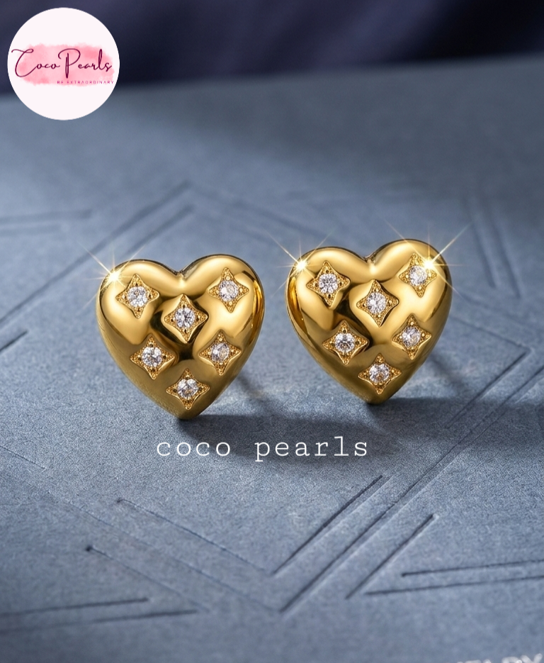 coco pearls stainless steel anti tarnish golden luxe heart sparkle diamond studded studs displayed on a grey background