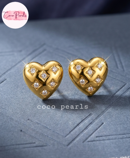 coco pearls stainless steel anti tarnish golden luxe heart sparkle diamond studded studs displayed on a grey background