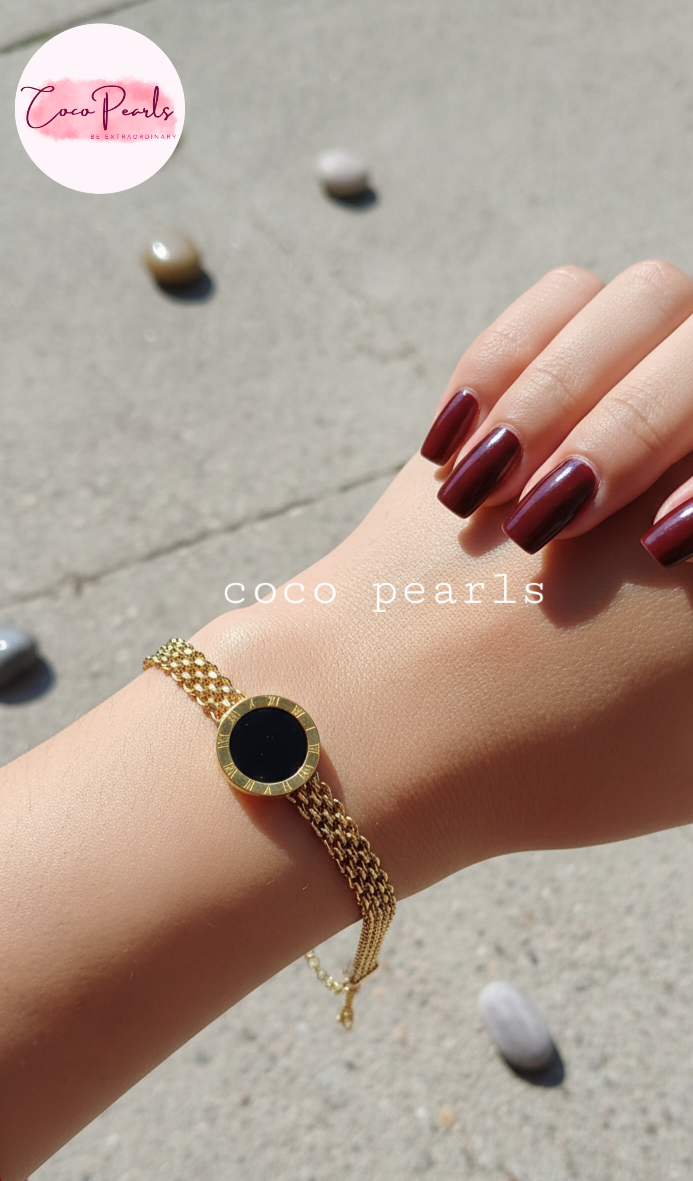 stainless steel anti tarnish Gold midnight aura bracelet with a black circle on a wrist