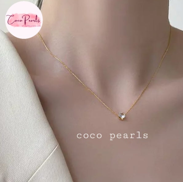 Coco Pearls Stainless Steel Anti Tarnish Gold milestone necklace with a diamond pendant on a mannequin