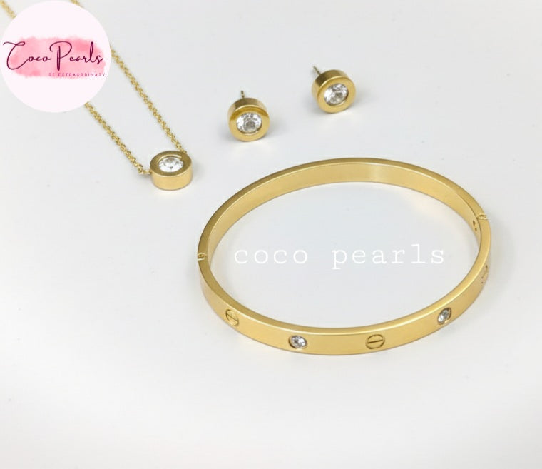Coco Pearls Stainless Steel Anti Tarnish Gold milestone jewelry set including necklace, earrings, and handcuff bracelet displayed on a light background
