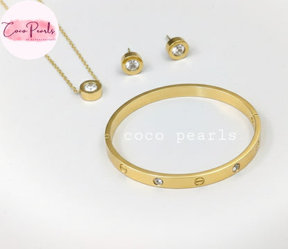 Coco Pearls Stainless Steel Anti Tarnish Gold milestone jewelry set including necklace, earrings, and handcuff bracelet displayed on a light background