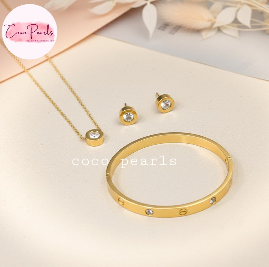 Coco Pearls Stainless Steel Anti Tarnish Gold milestone jewelry set including necklace, earrings, and handcuff bracelet displayed on a light background