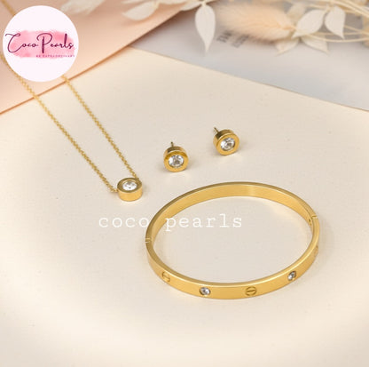 Coco Pearls Stainless Steel Anti Tarnish Gold milestone jewelry set including necklace, earrings, and handcuff bracelet displayed on a light background