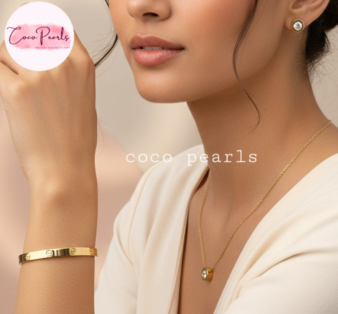 Coco Pearls Stainless Steel Anti Tarnish Gold milestone jewelry set including necklace, earrings, and handcuff bracelet displayed on a women