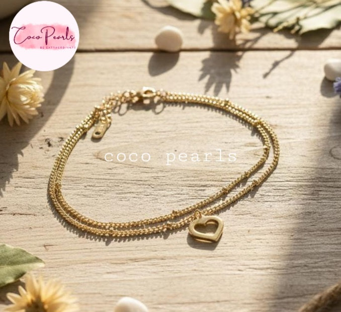 Coco Pearls Stainless Steel Anti Tarnish Gold minimal love anklet with heart charm on a wooden surface