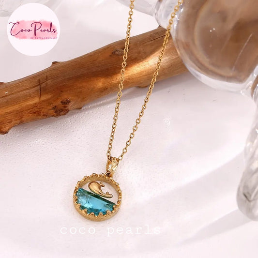 Coco Pearls Stainless steel anti tarnish gold and blue ocean bliss necklace with gold dolphin in water look