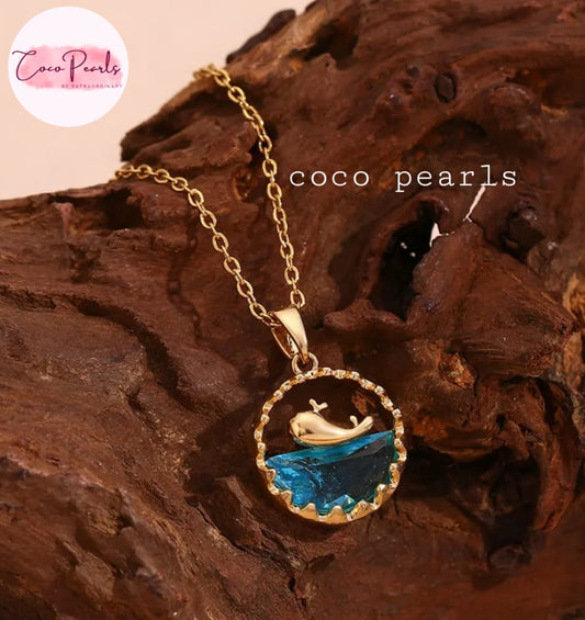Coco Pearls Stainless steel anti tarnish gold and blue ocean bliss necklace with gold dolphin in water look