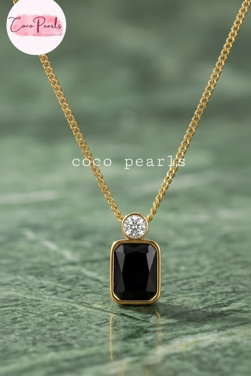 Coco Pearls Stainless Steel Anti Tarnish onyx obsession Gold necklace with a black rectangular gemstone and a small round gemstone on top with a gold chain.