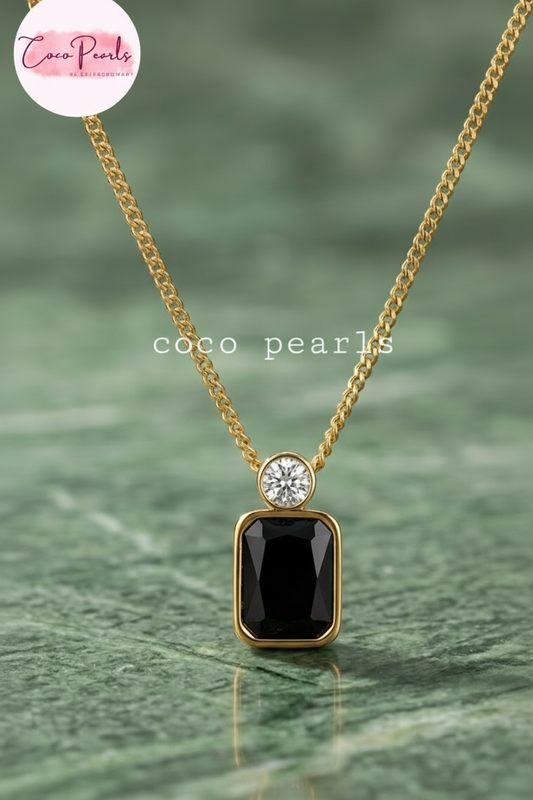 Coco Pearls Stainless Steel Anti Tarnish onyx obsession Gold necklace with a black rectangular gemstone and a small round gemstone on top with a gold chain.