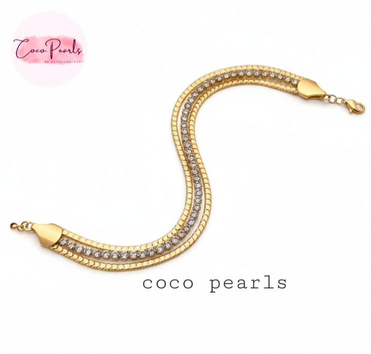 Coco Pearls Stainless Steel Anti tarnish gold radiant river bracelet. 3 layer stack bracelet with diamond studded chain and simple chain on either side displayed on white background.