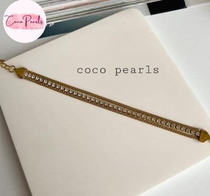 Coco Pearls Stainless Steel Anti tarnish gold radiant river bracelet. 3 layer stack bracelet with diamond studded line with chain on both side displayed on white background.