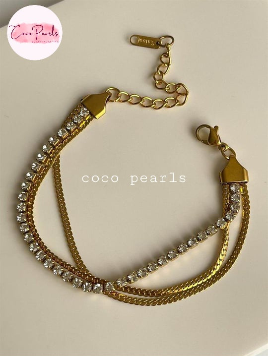 Coco Pearls Stainless Steel Anti tarnish gold radiant river bracelet. 3 layer stack bracelet with diamond line with chain on either side displayed on white background.