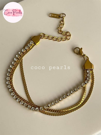 Coco Pearls Stainless Steel Anti tarnish gold radiant river bracelet. 3 layer stack bracelet with diamond line with chain on either side displayed on white background.