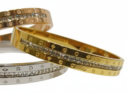 Coco Pearls Stainless Steel Anti tarnish gold radiant spark handcuff bangle bracelet with diamond accents on white surface