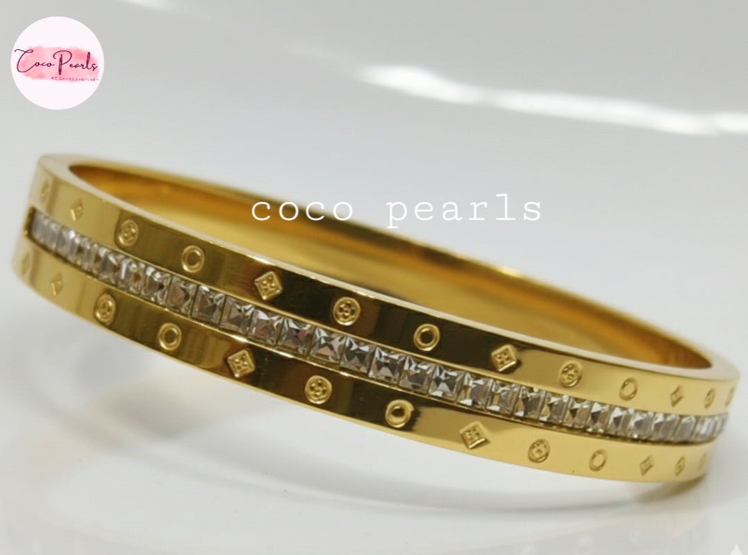 Coco Pearls Stainless Steel Anti tarnish gold radiant spark handcuff bangle bracelet with diamond accents on a white background
