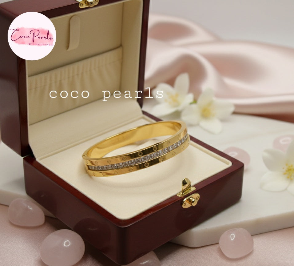 Coco Pearls Stainless Steel Anti tarnish gold radiant spark handcuff bangle bracelet with diamond accents in a jewelry box