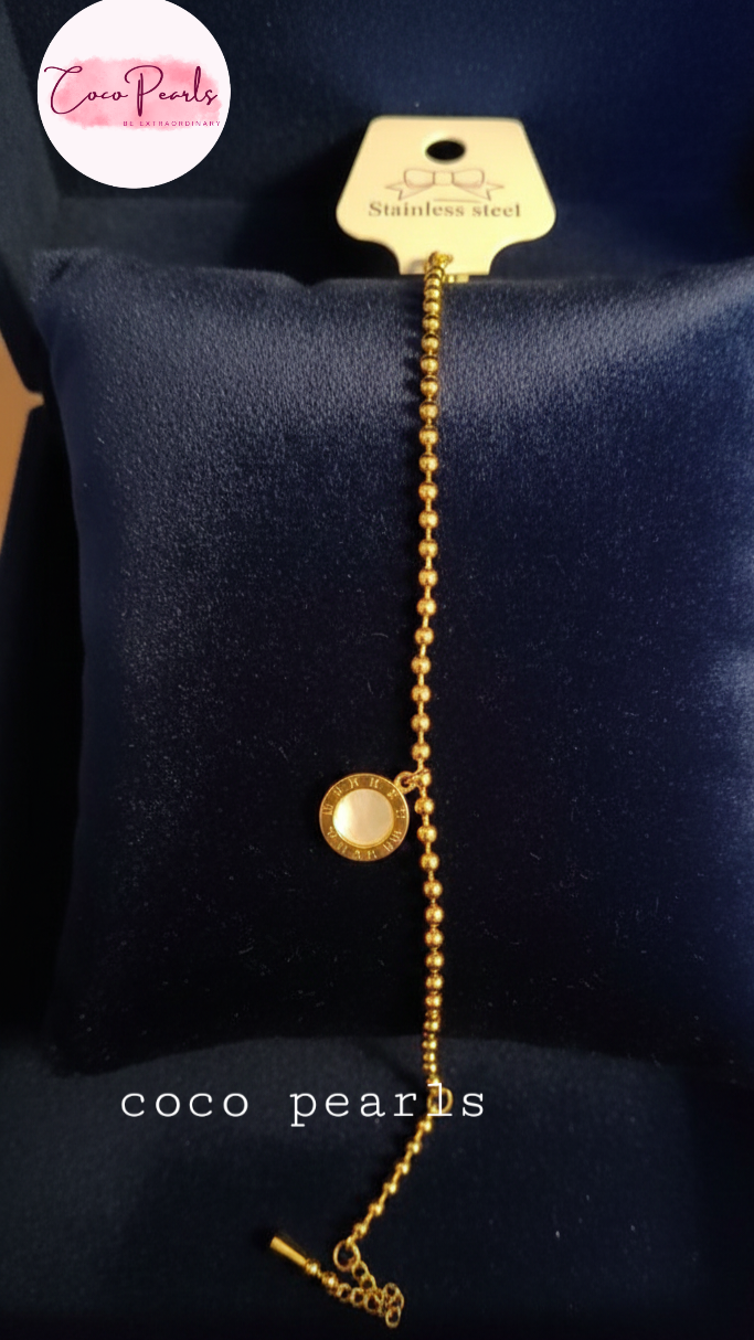 Coco Pearls Stainless Steel Anti tarnish Golden roman bead bracelet with bead chain and double sided roman hanging charm. one side white one side black.