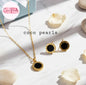 Coco Pearls Stainless Steel Anti Tarnish Gold roman set necklace and earrings with black stones and numerals on a white surface