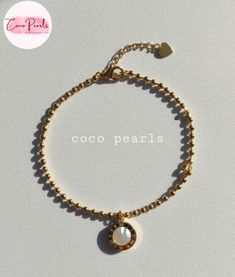 Coco Pearls Stainless Steel Anti tarnish Golden roman bead bracelet with bead chain and double sided roman hanging charm. one side white one side black. displayed white background