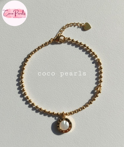Coco Pearls Stainless Steel Anti tarnish Golden roman bead bracelet with bead chain and double sided roman hanging charm. one side white one side black. displayed white background