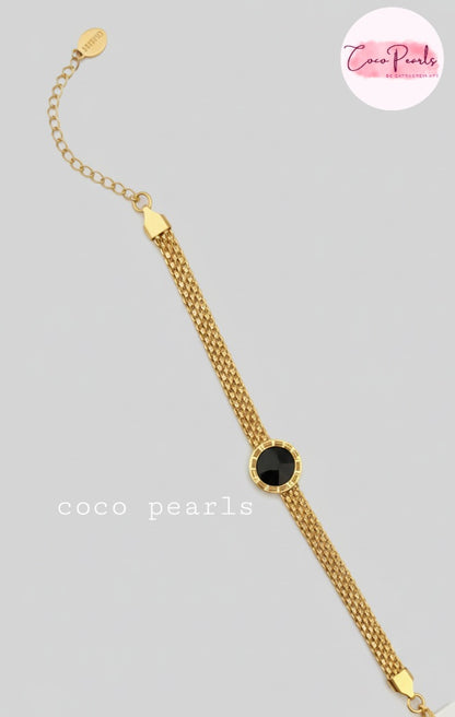 Coco Pearls Stainless steel Ani Tarnish Gold roman fake watch mesh bracelet with a black fake watch center on a white background