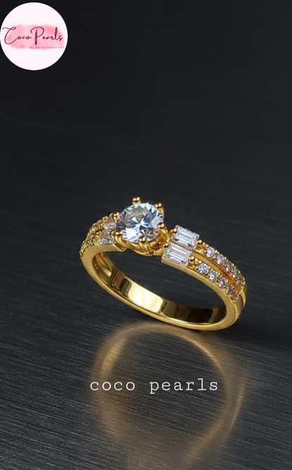 coco pearls stainless steel anti tarnish gold royal  adjustable diamond studded ring displayed on  metallic surface