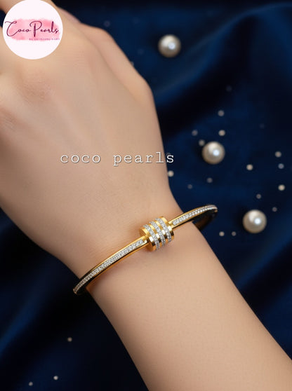 coco pearls stainless steel anti tarnish gold shimmering crown diamond studded handcuff displayed on hand