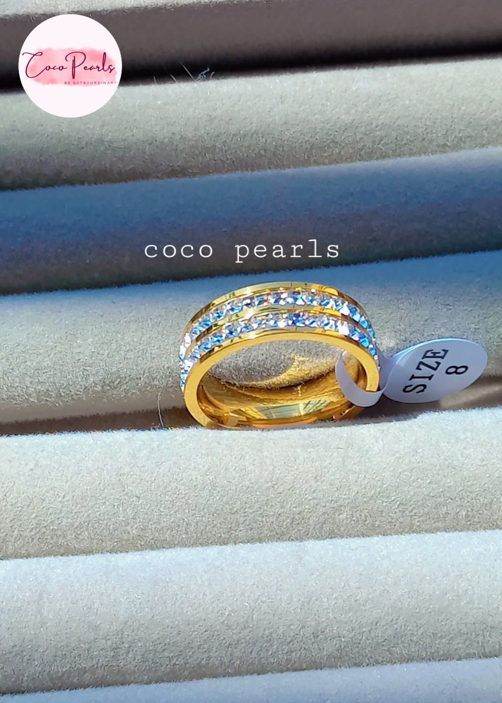 coco pearls stainless steel anti tarnish golden shimmering elegance ring displayed on a grey background