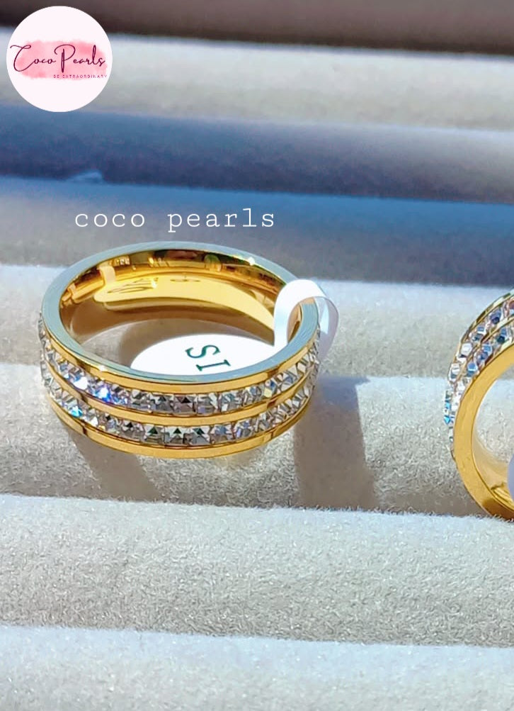 coco pearls stainless steel anti tarnish golden shimmering elegance ring displayed on a grey background