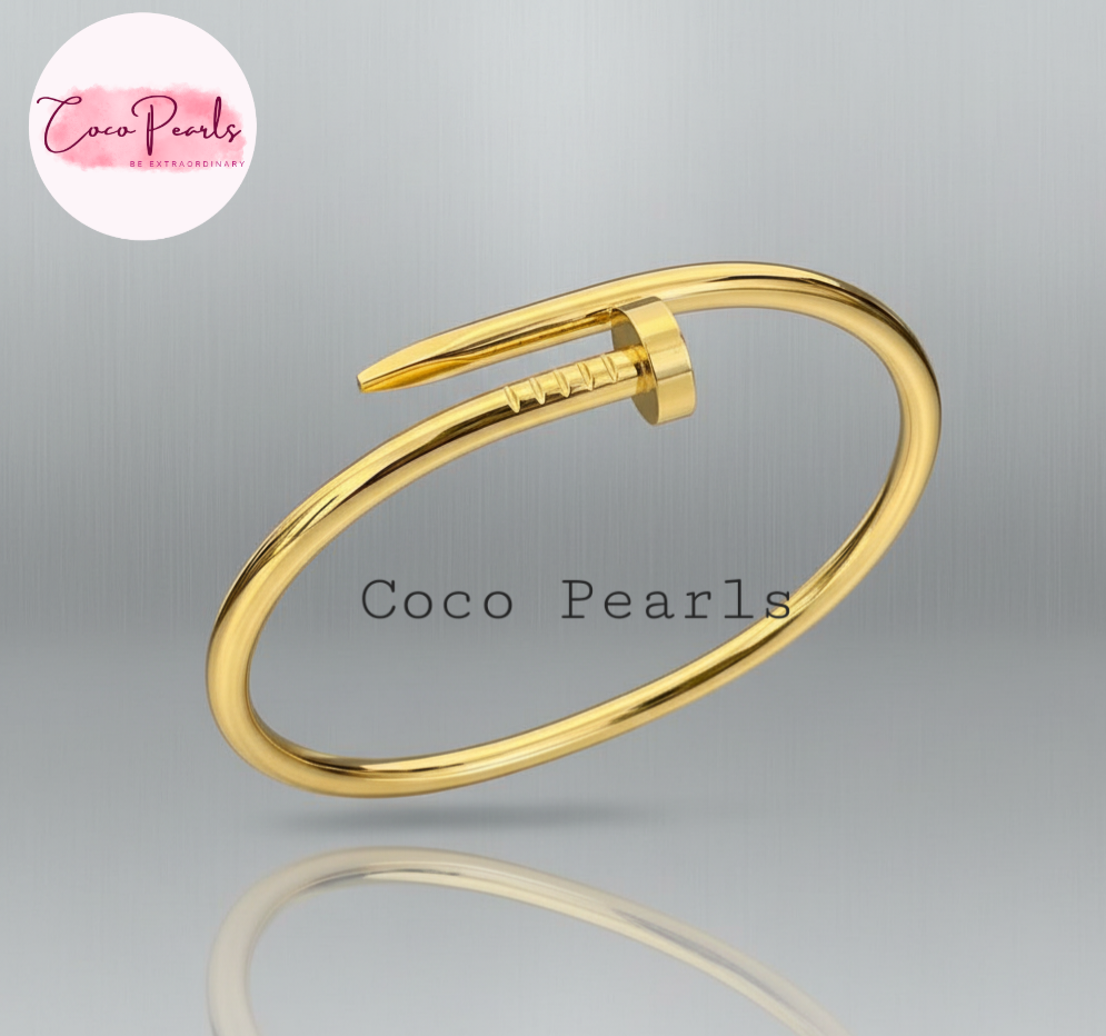 Coco Pearls Stainless Steel Anti Tarnish Gold  sleek nail bangle bracelet on a gray background 