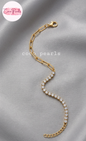 Coxo pearls stainless Steel anti tarnish Gold bracelet with clear stones on a light beige background