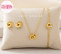 Coco Pearls Stainless Steel Anti tarnish Gold sparkle loop jewelry set with diamond studded interlocking circle necklace, earrings, and bracelet on a beige pillow 