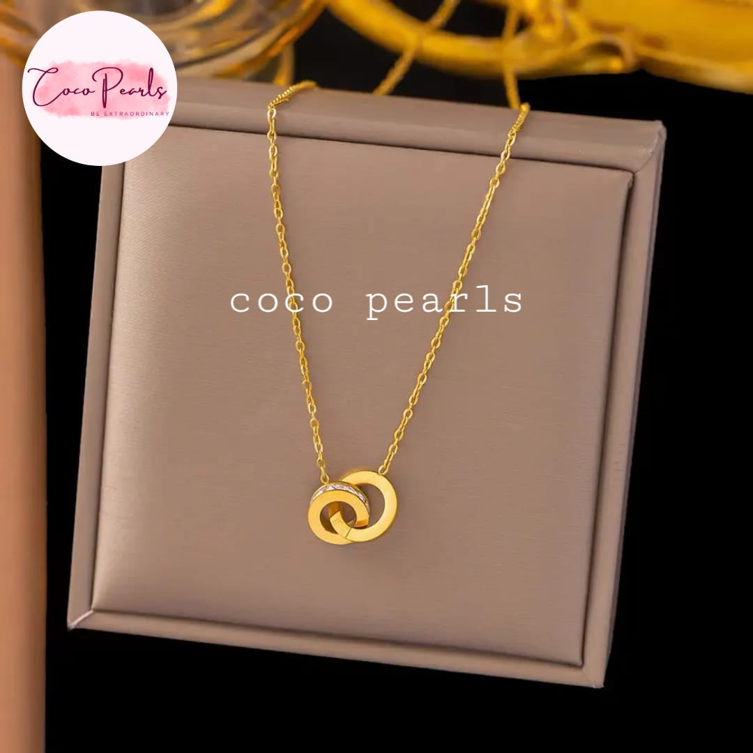 Coco Pearls Stainless Steel Anti tarnish Gold sparkle loop jewelry with diamond studded bracelet on a simple background